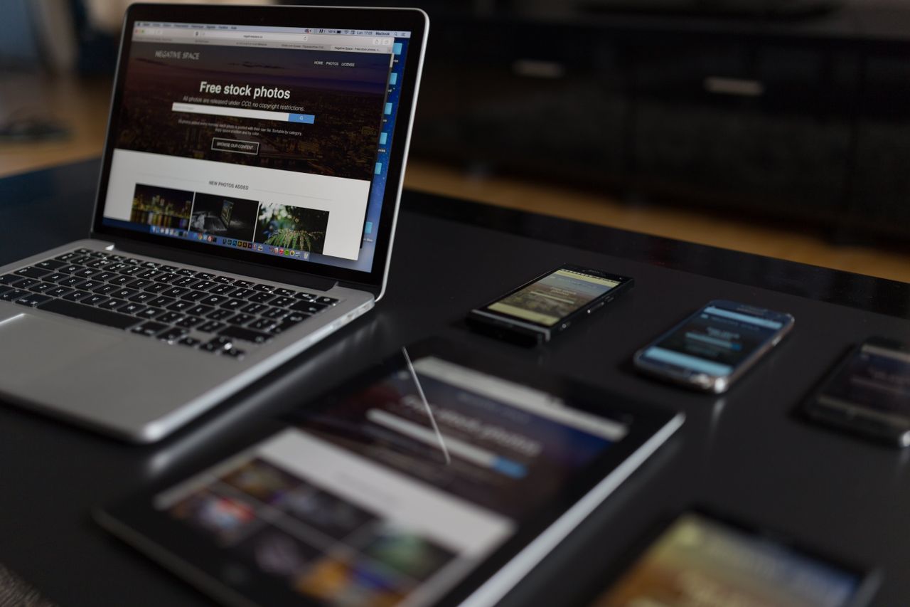 A modern work setting featuring a laptop, tablet, and smartphones, well suited to technology and freelance work.